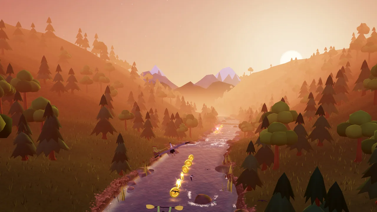 A winding river through a wooded mountain valley beneath the warm sunset.